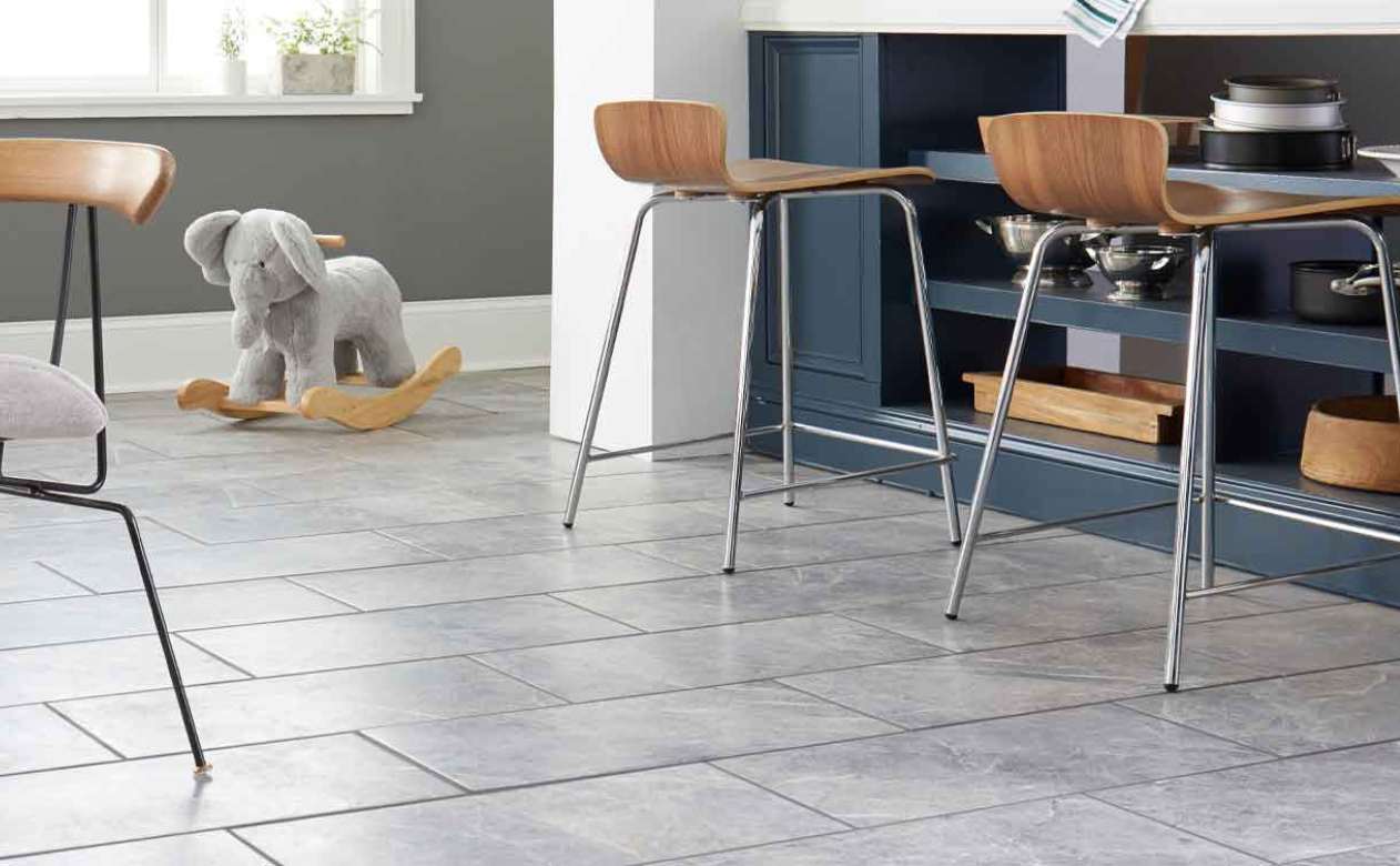 tile flooring in kitchen with blue accents and wood barstools